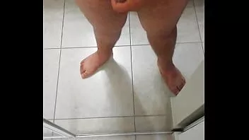Play Chubby guy wanking his little cock and fingering his arse in the mirror.